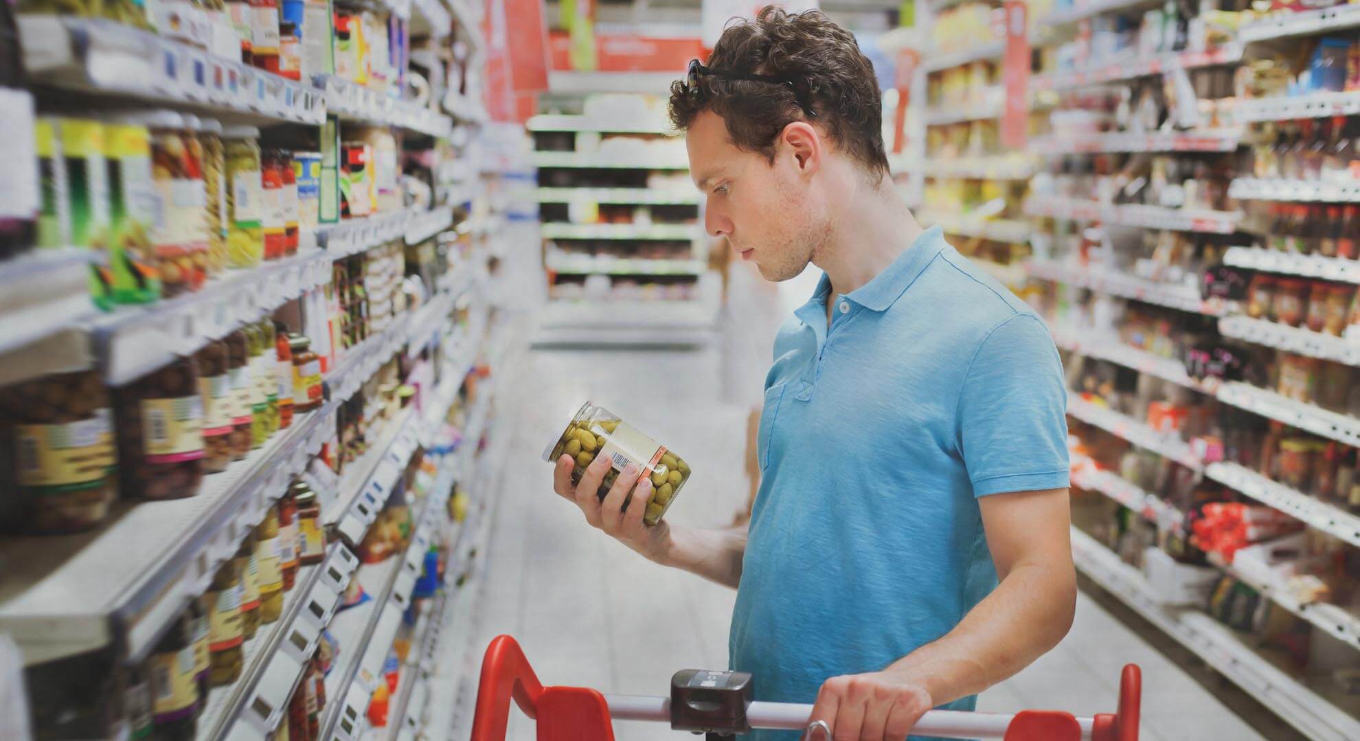 A person looking at food products in a supermarket aisle
