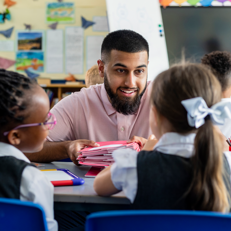 A teacher in a classroom talking to young children