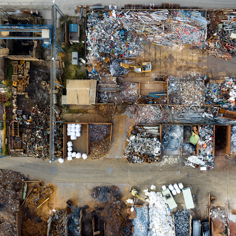An overhead image of a construction site with different waste materials in organised piles