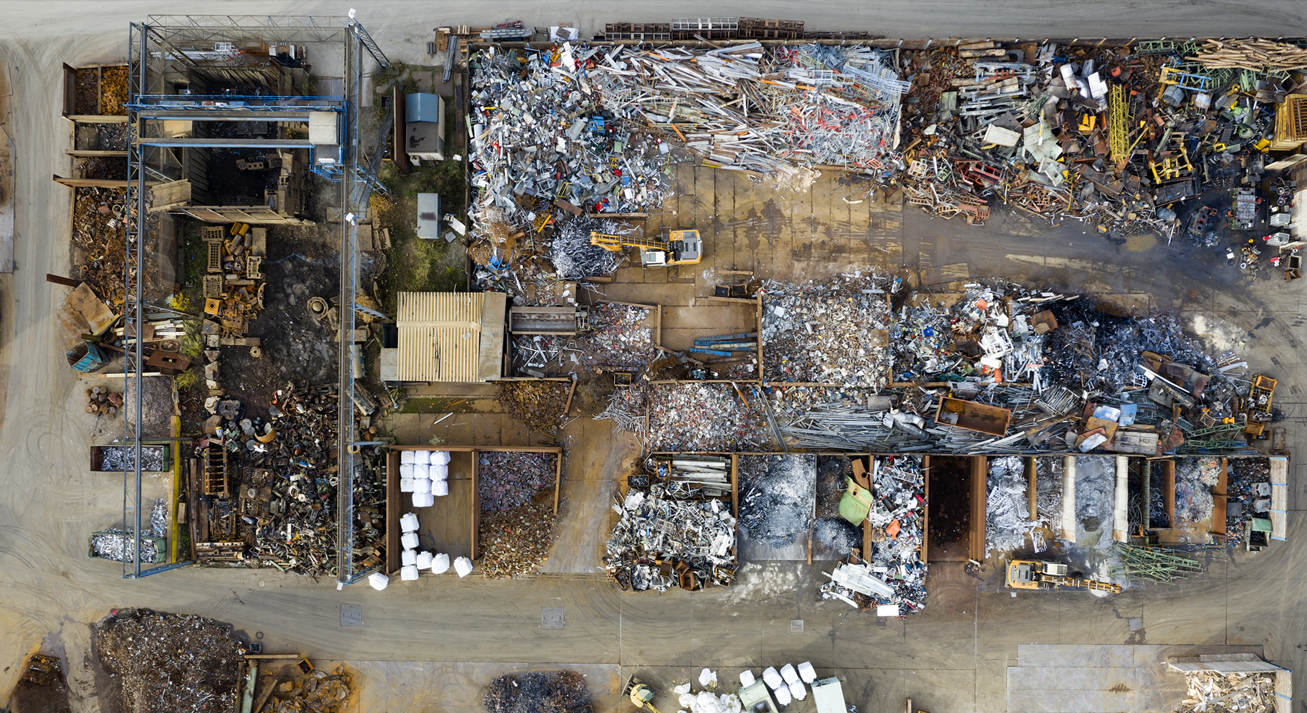An overhead image of a construction site with different waste materials in organised piles