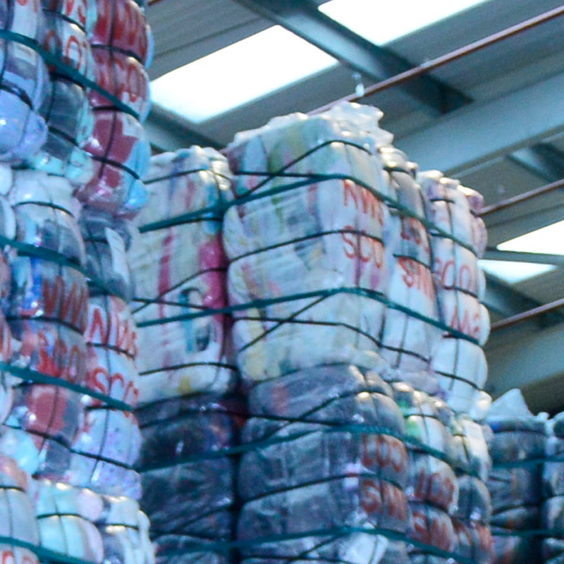 Large bales of clothing in a warehouse