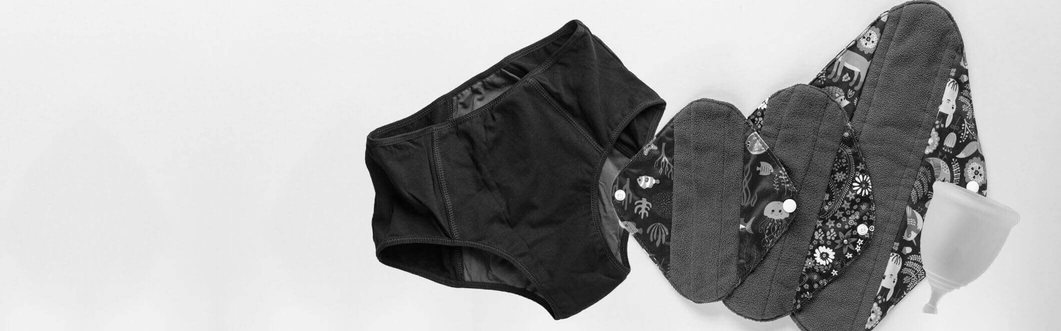 Black and white image of a pair of Period Pants, Reusable Cloth Pads and a Menstrual Cup