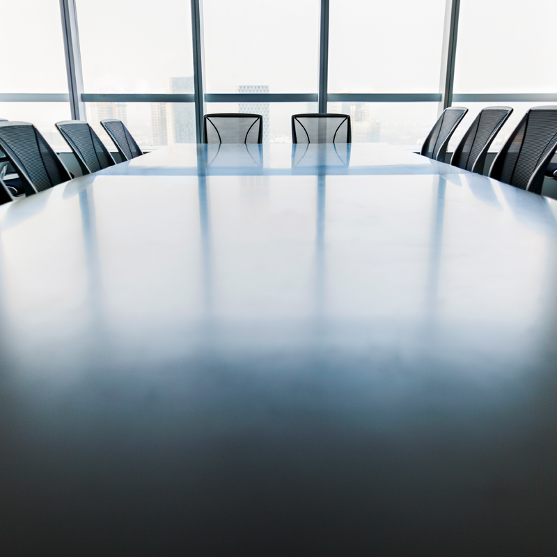 A board room with chairs around a table