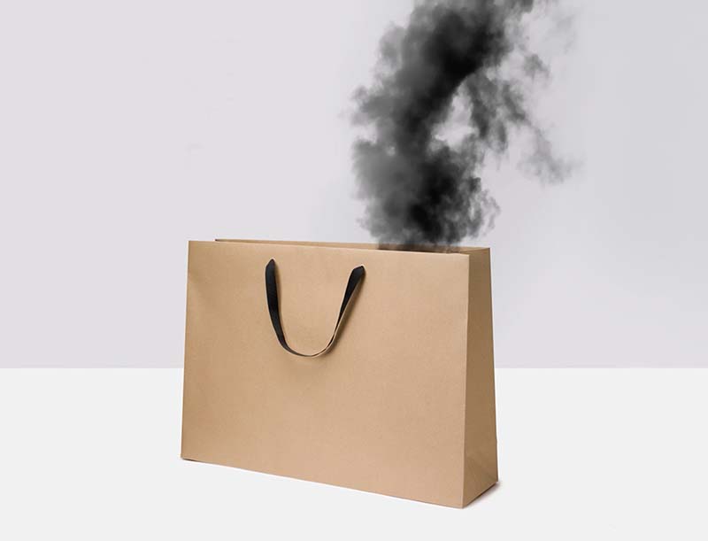 Image of a shopping bag with black smoke pouring out of it