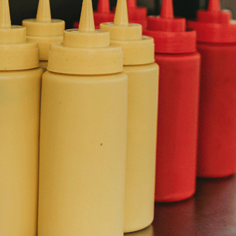 Reusable mustard and ketchup bottles at a restaurant 