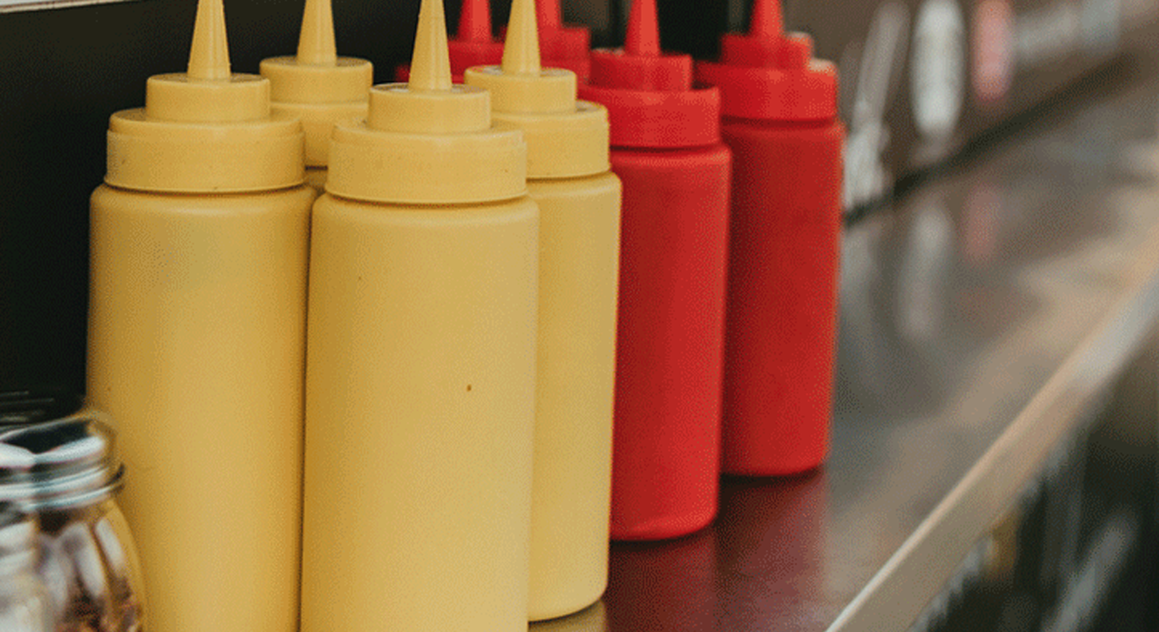 Reusable mustard and ketchup bottles at a restaurant