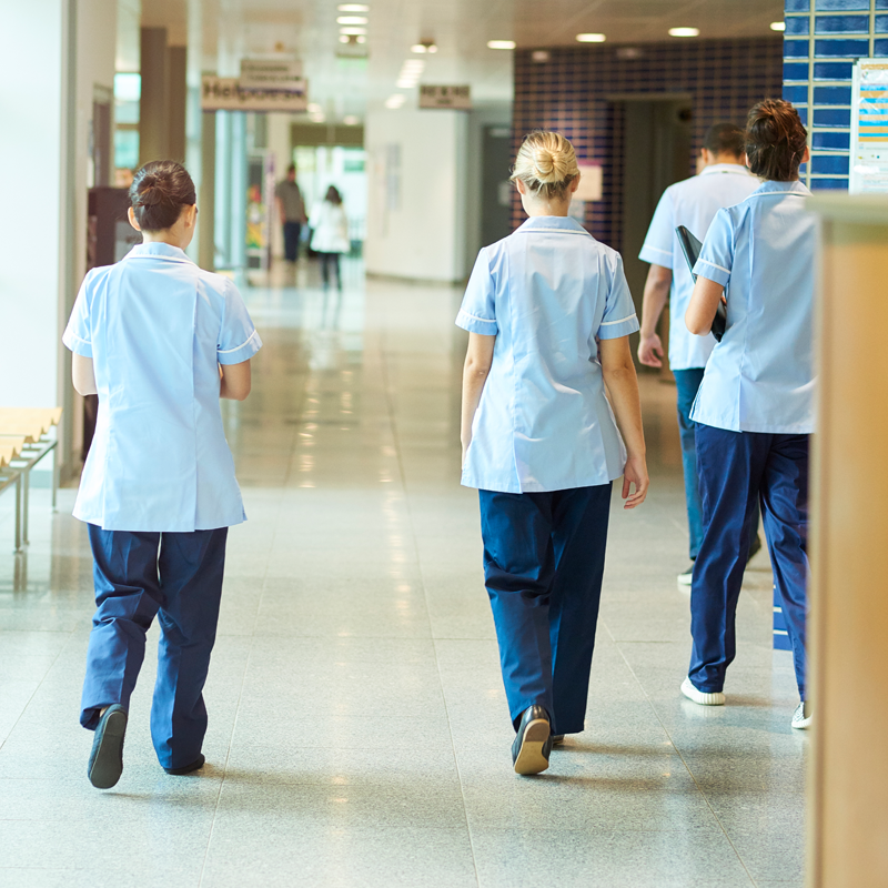 NHS Scotland staff members walking down a corridor