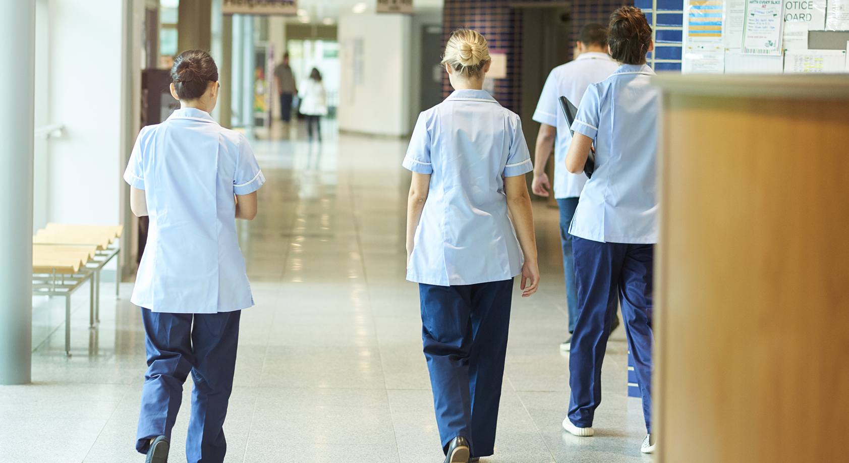 NHS Scotland staff members walking down a corridor