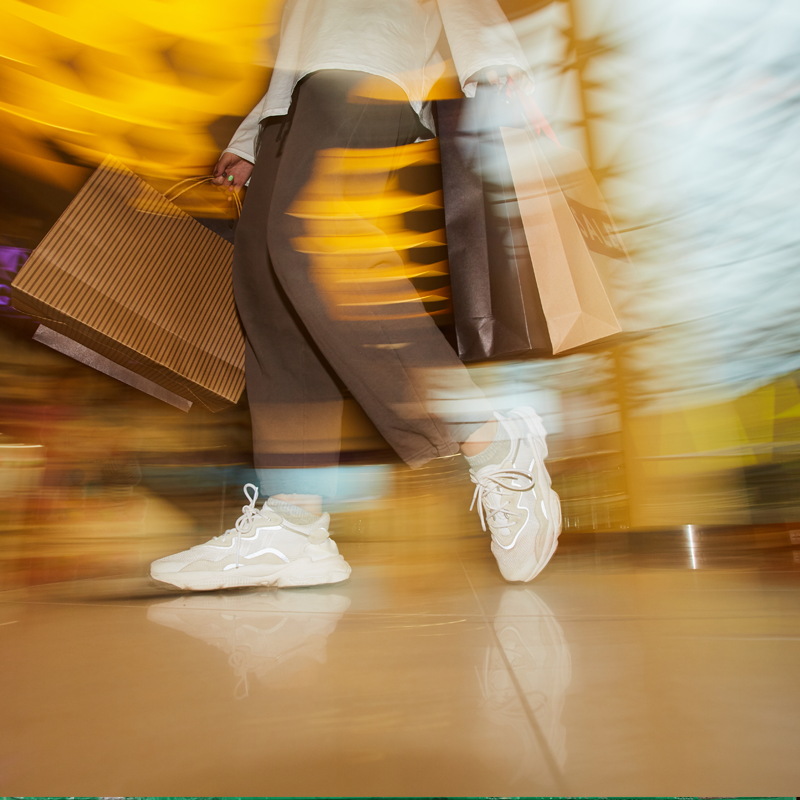 An abstract image showing a person clothes shopping