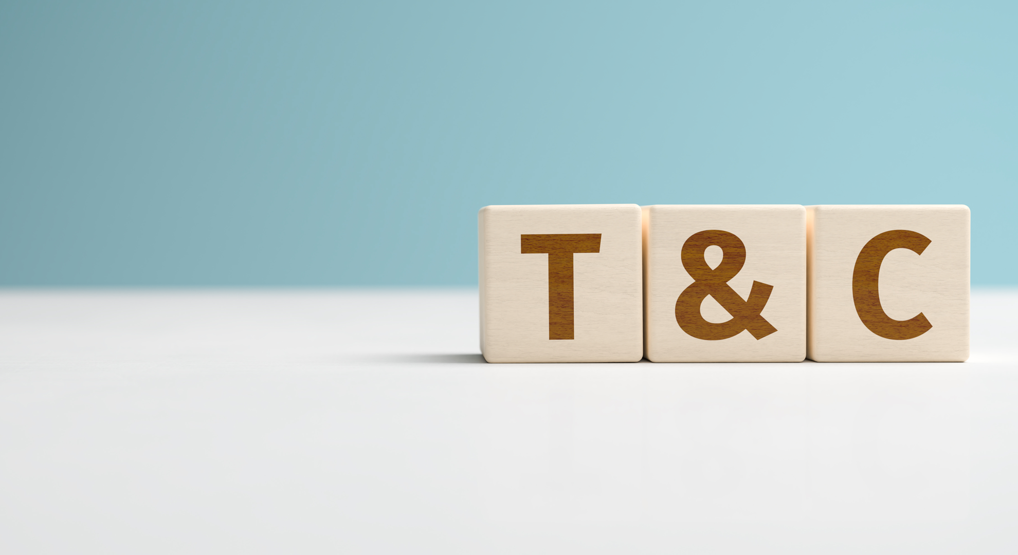 Three wooden blocks with the letters T ampersand and C