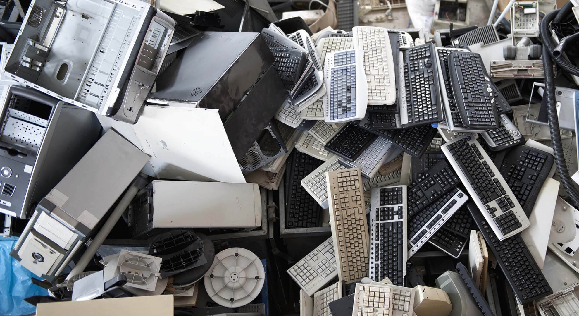 A large pile of old and broken computer equipment
