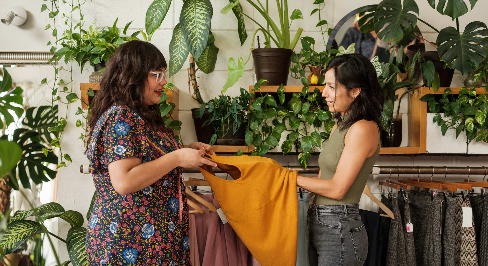 Image of women exchanging preloved clothes