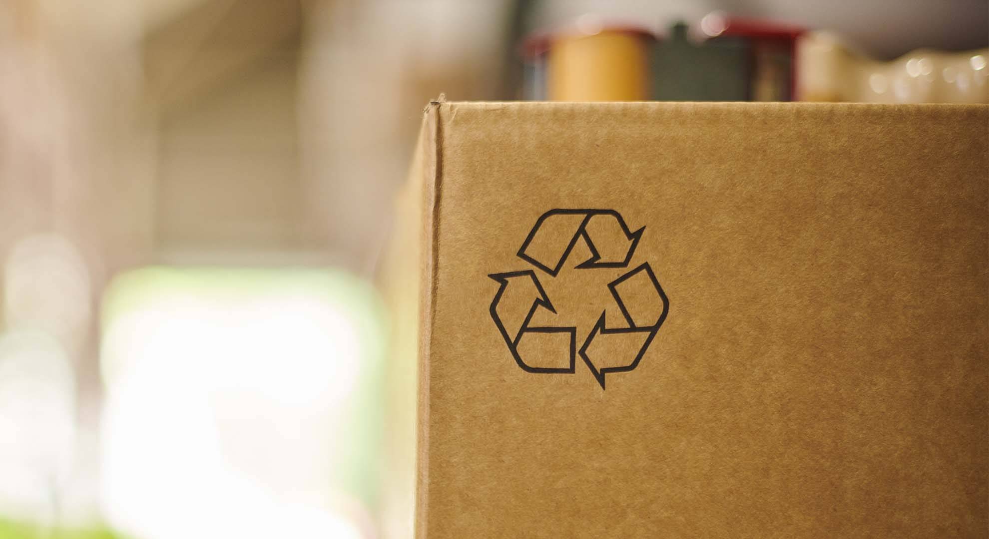 Photo of a cardboard box displaying the mobius look recycling symbol