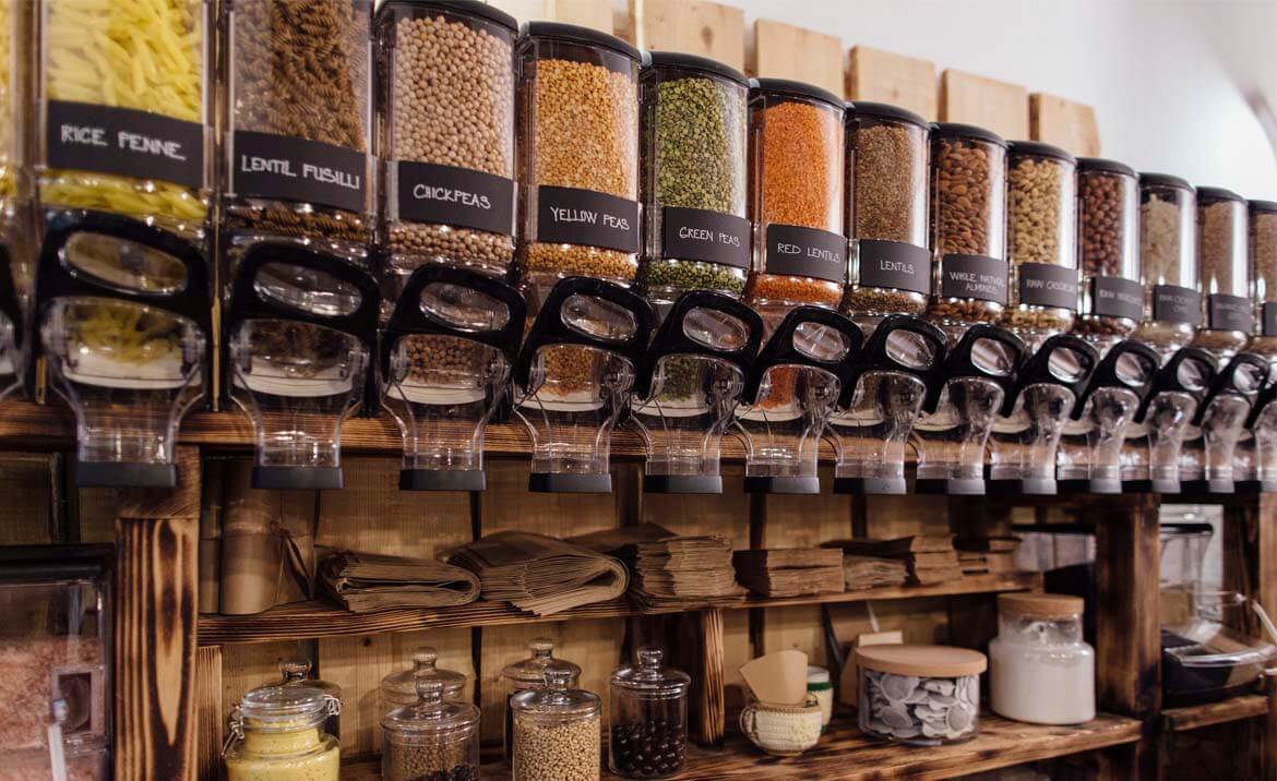 Row of dried good dispensers in a zero waste refill store