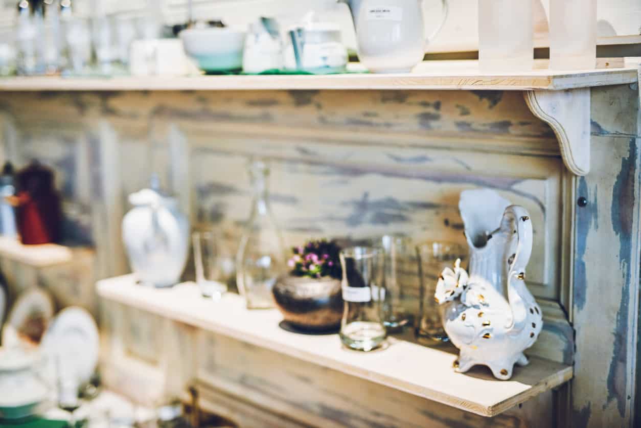 Shot of various ceramic and glass goods on a shelf in a vintage store