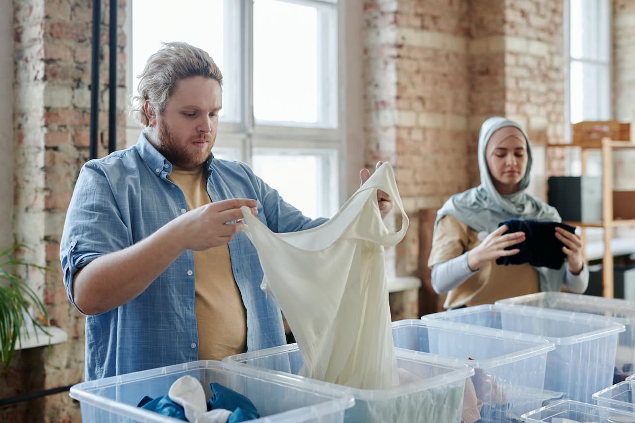 person sorting clothing donations