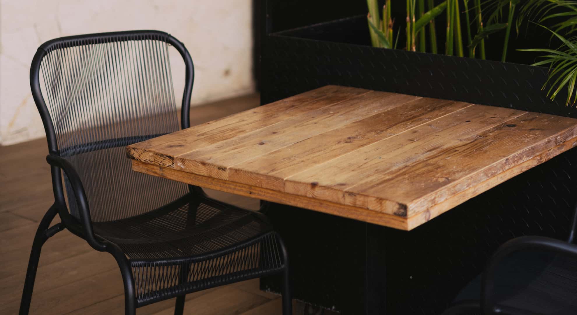 Brown Wooden Table in Front of Green Leafed Plant