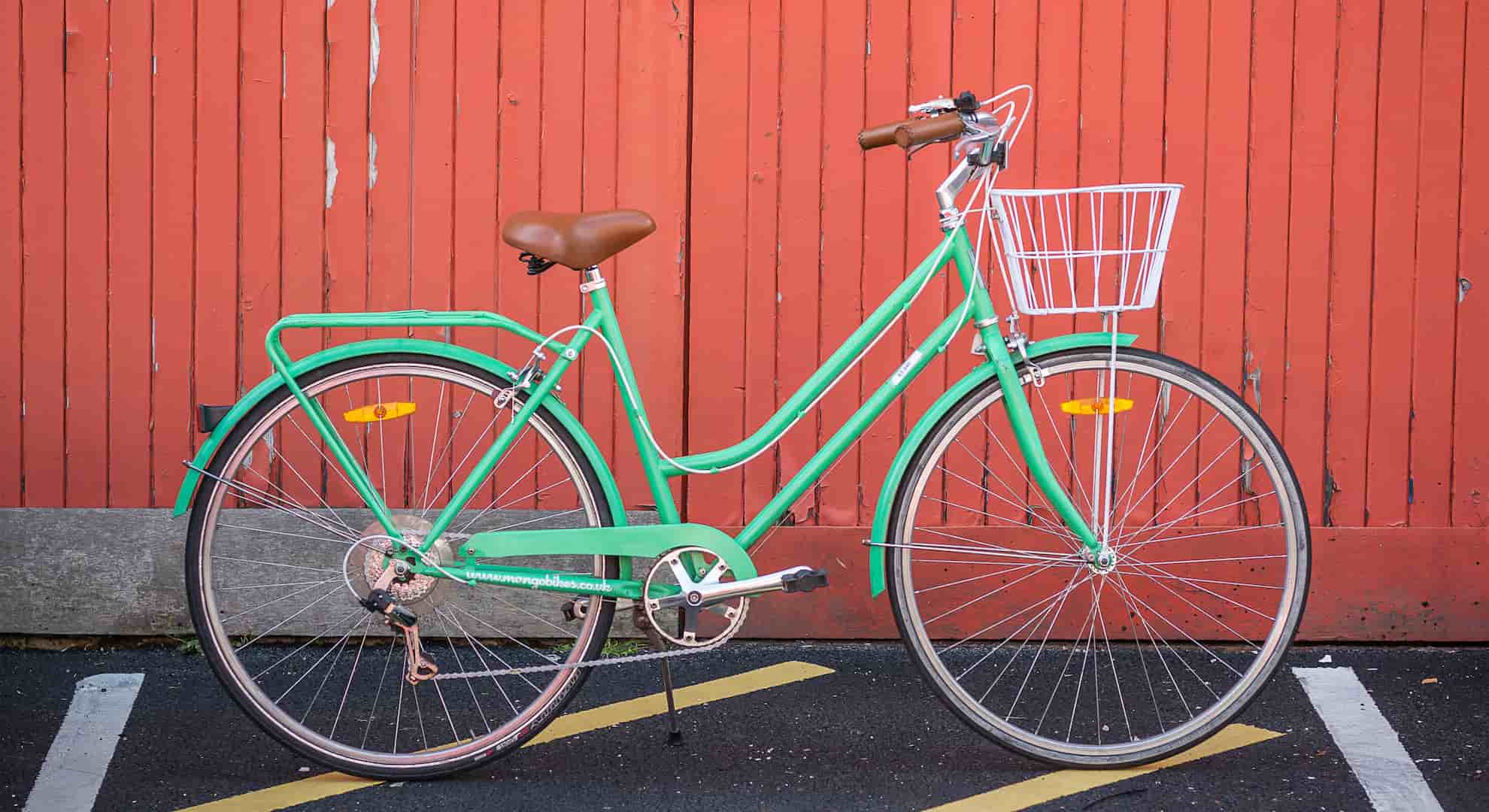 Green bicycle on red background