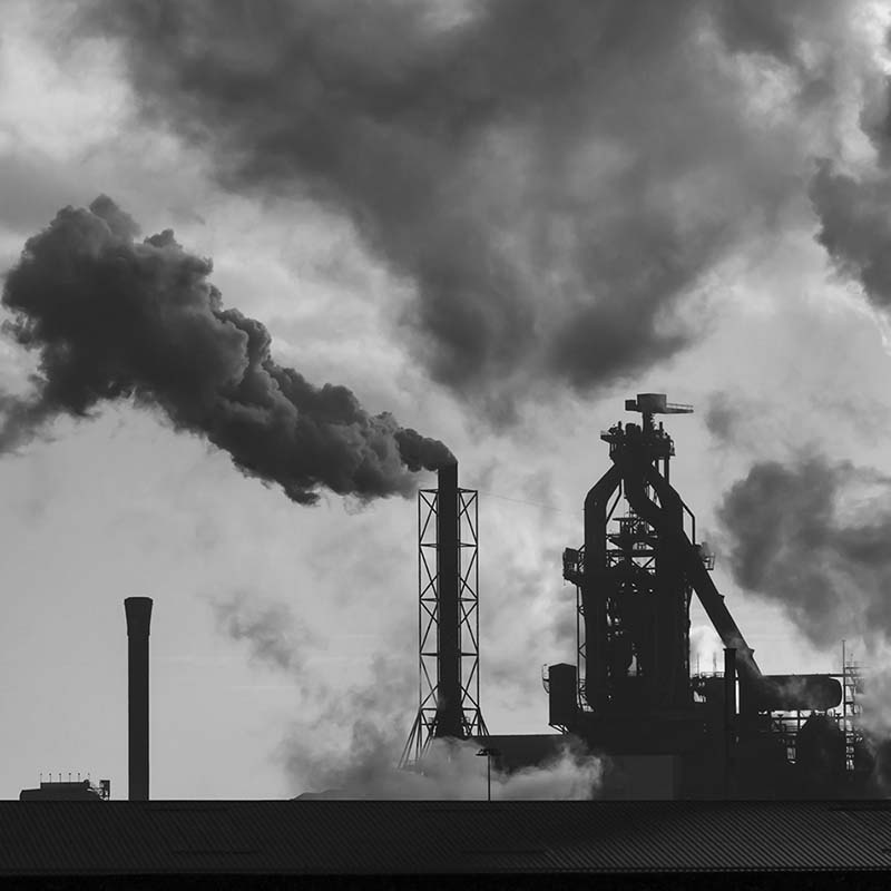 Black and white photo of factory chimneys