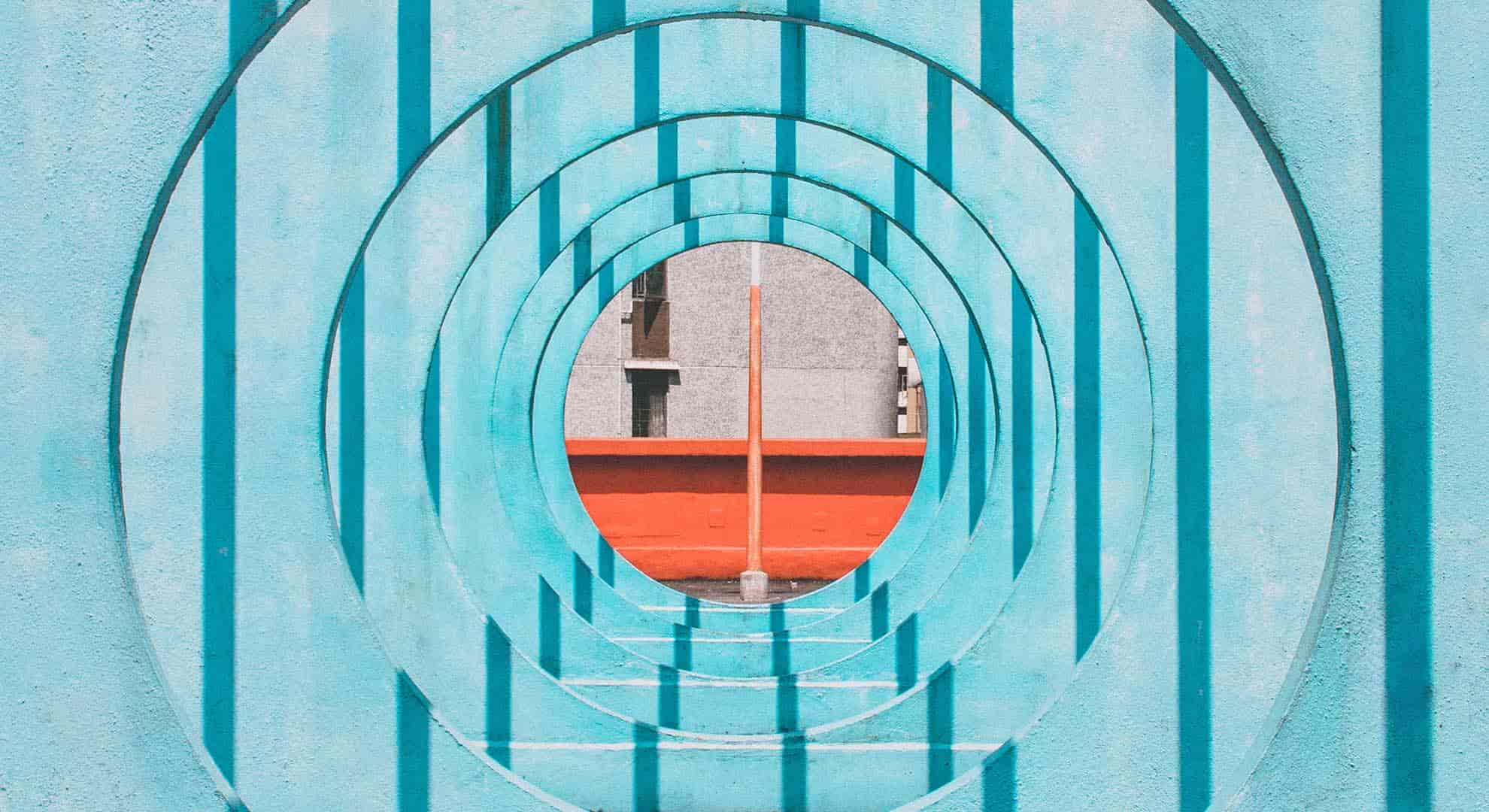 Photo looking through light blue walls with circles cut out