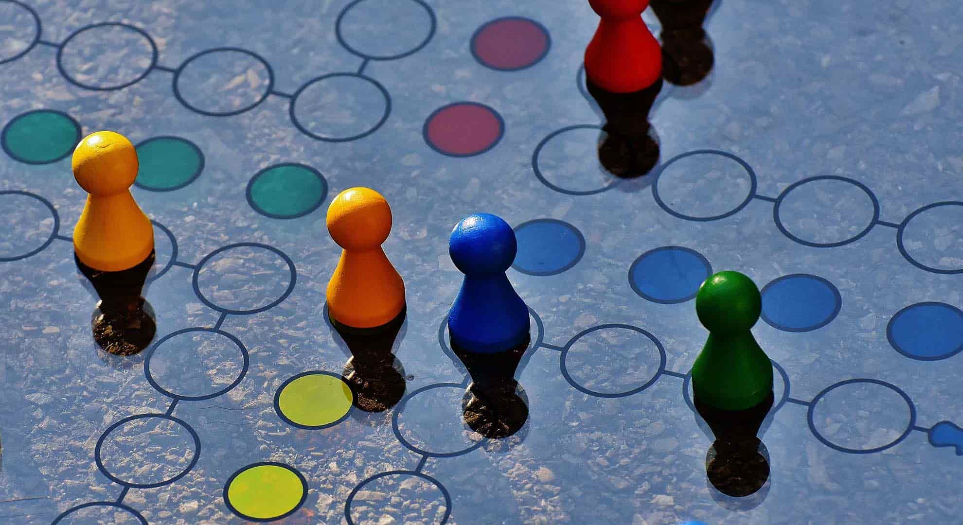 Photo of a board game with coloured pieces moving along a circle path