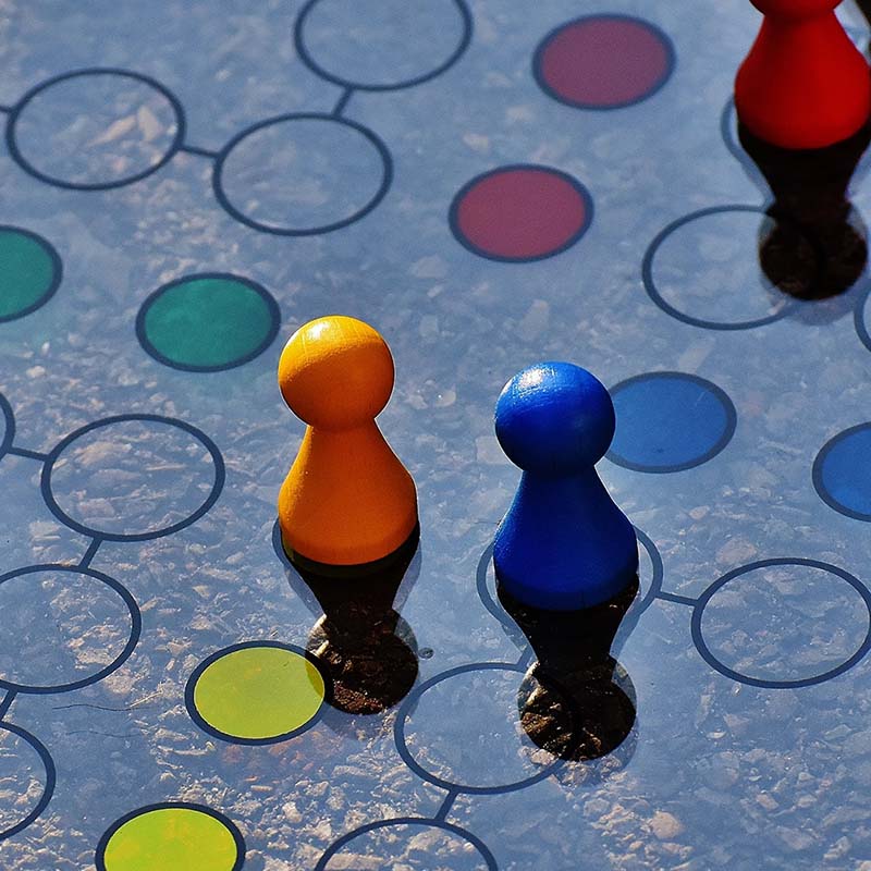Photo of a board game with coloured pieces moving along a circle path