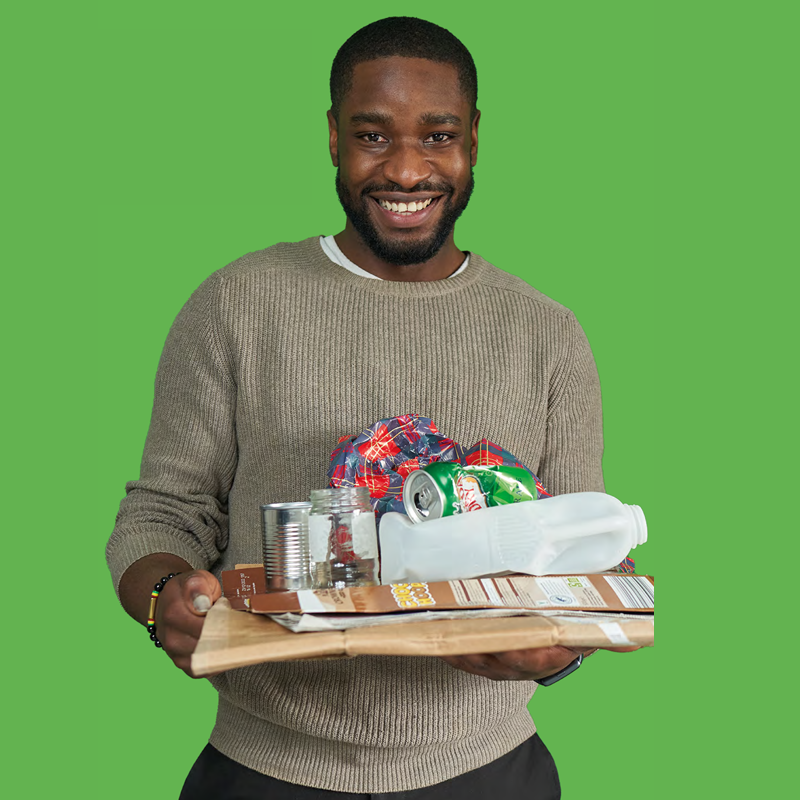 Green rectangle with a person holding a variety of recyclable materials.