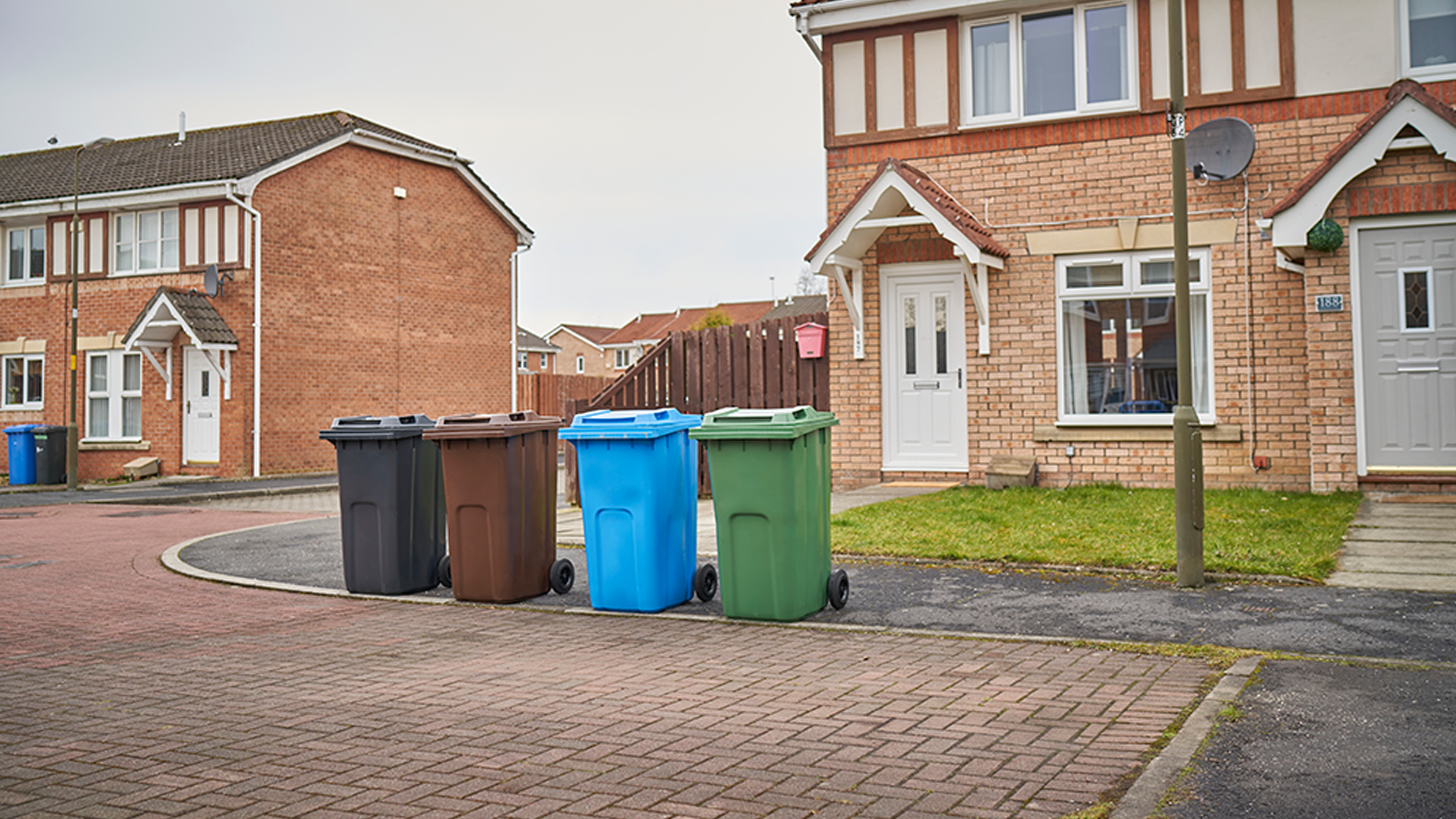 A street with different recycling bins out for collection