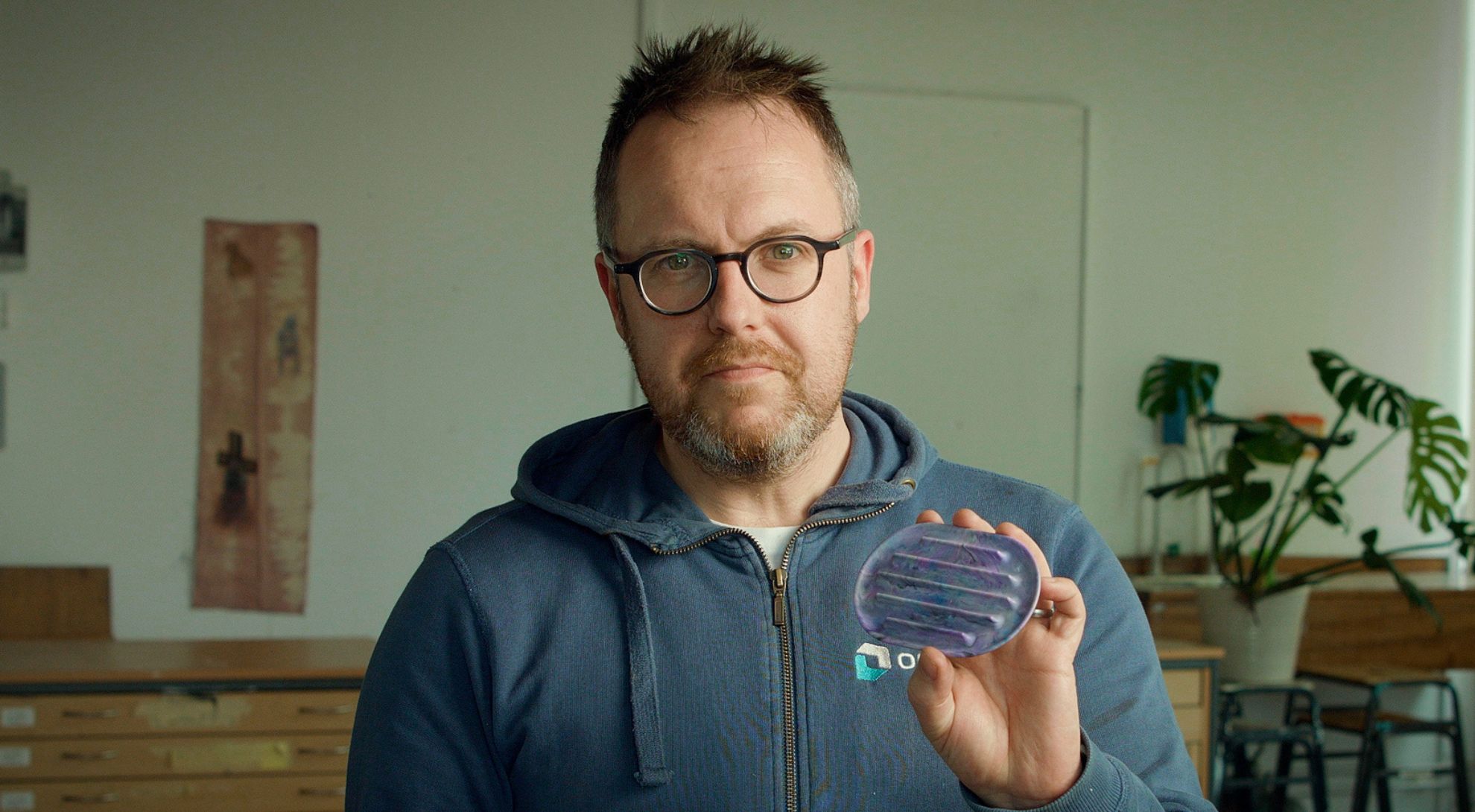 Man holding product remanufactured from waste plastic