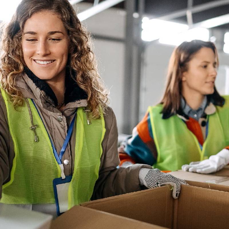 two-women-with-cardboard-packaging-square