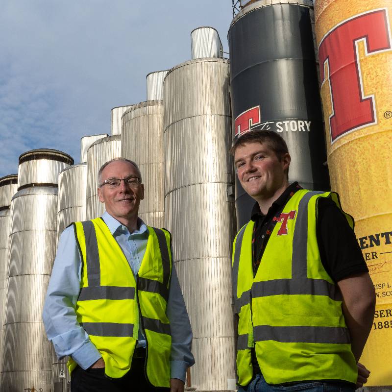 2 men in front of brewery