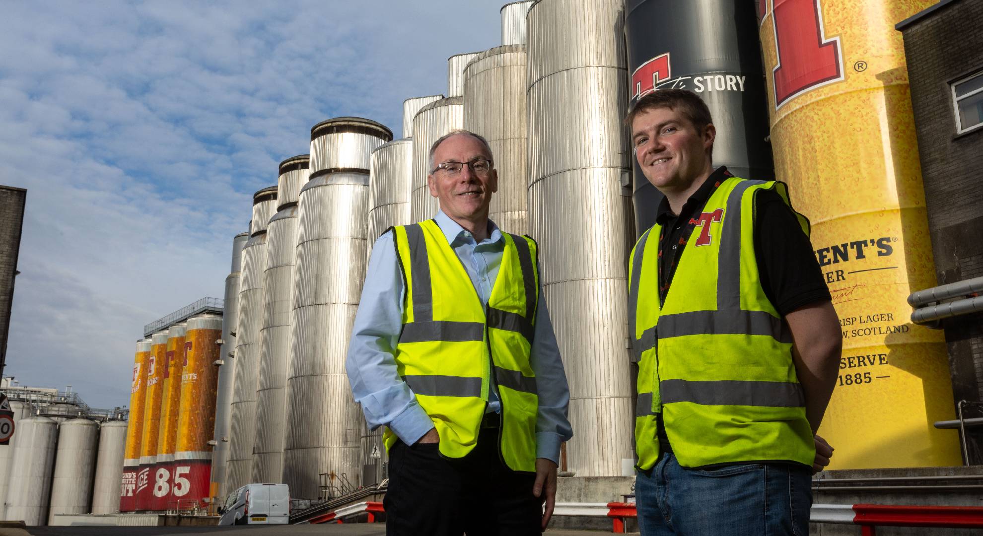 2 men in front of brewery