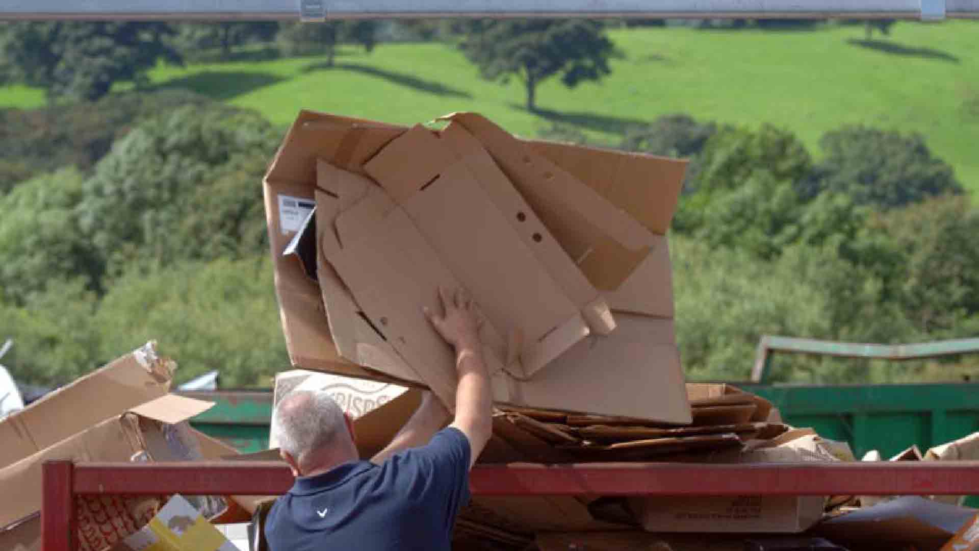 Person recycling at household waste recycling centre