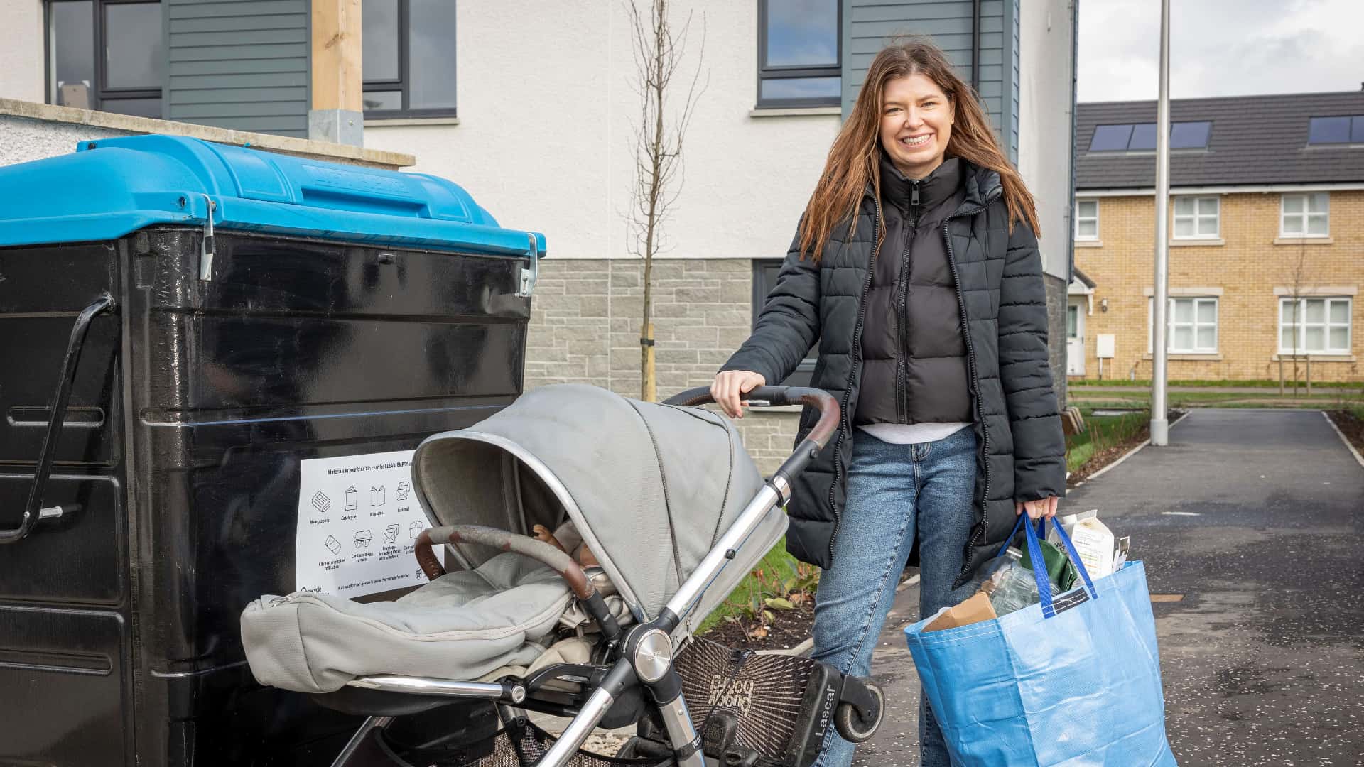 Person with family recycling in communal bin