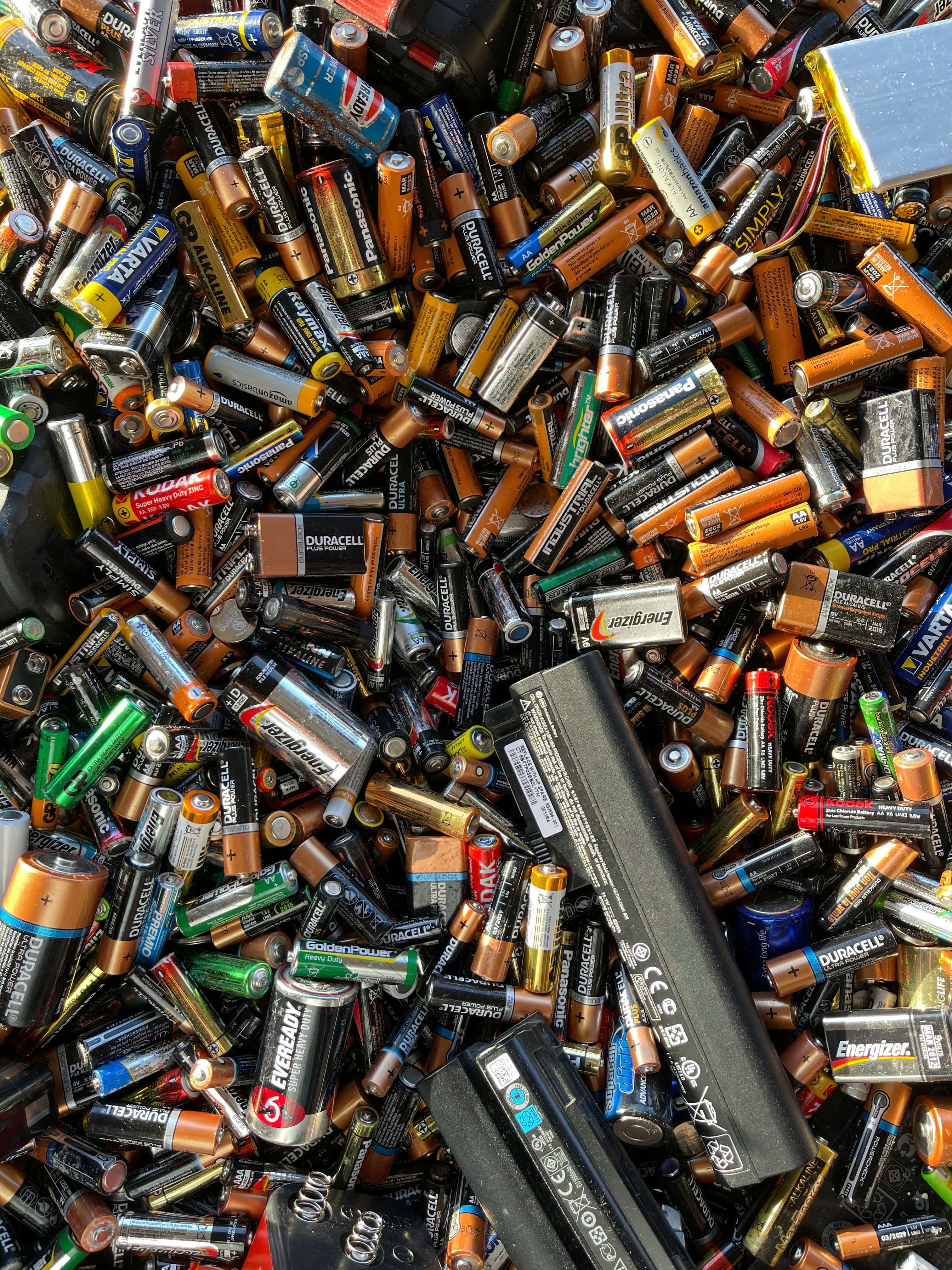 An image filled entirely by various types of used batteries