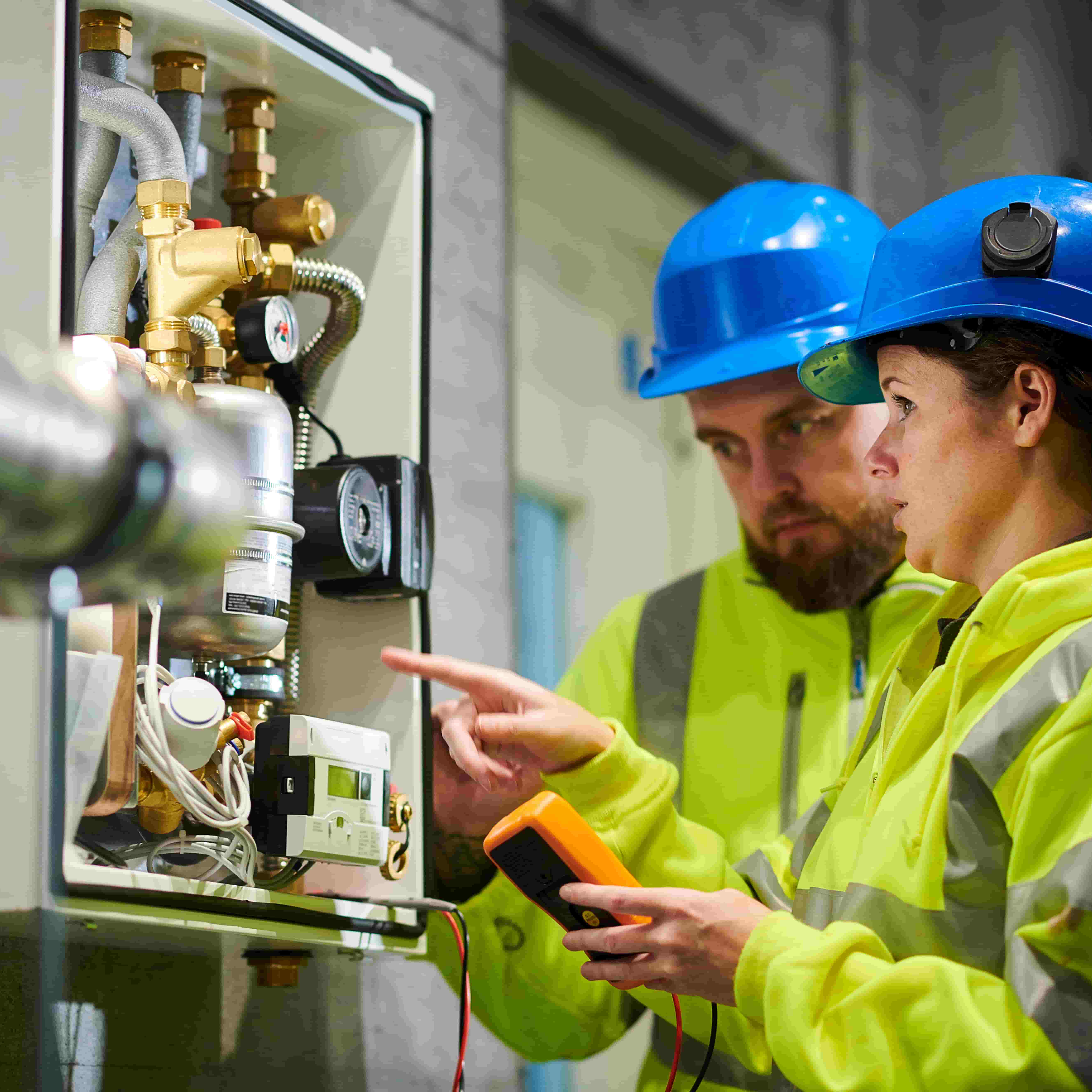 People looking at a boiler