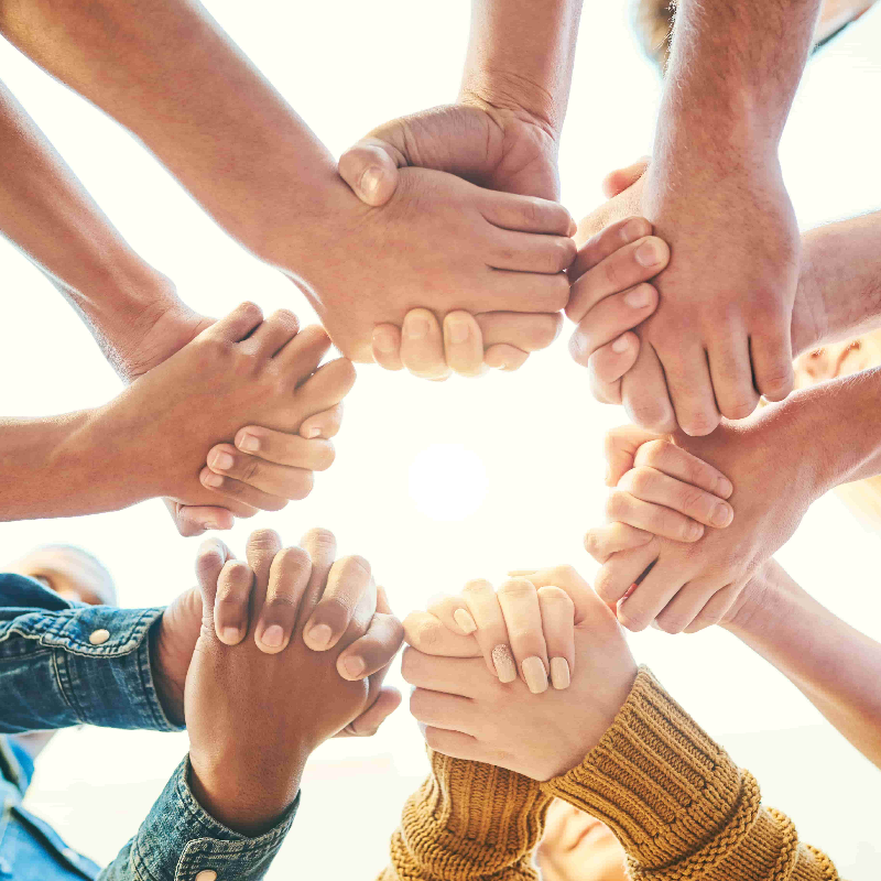 Multiple people holding hands together