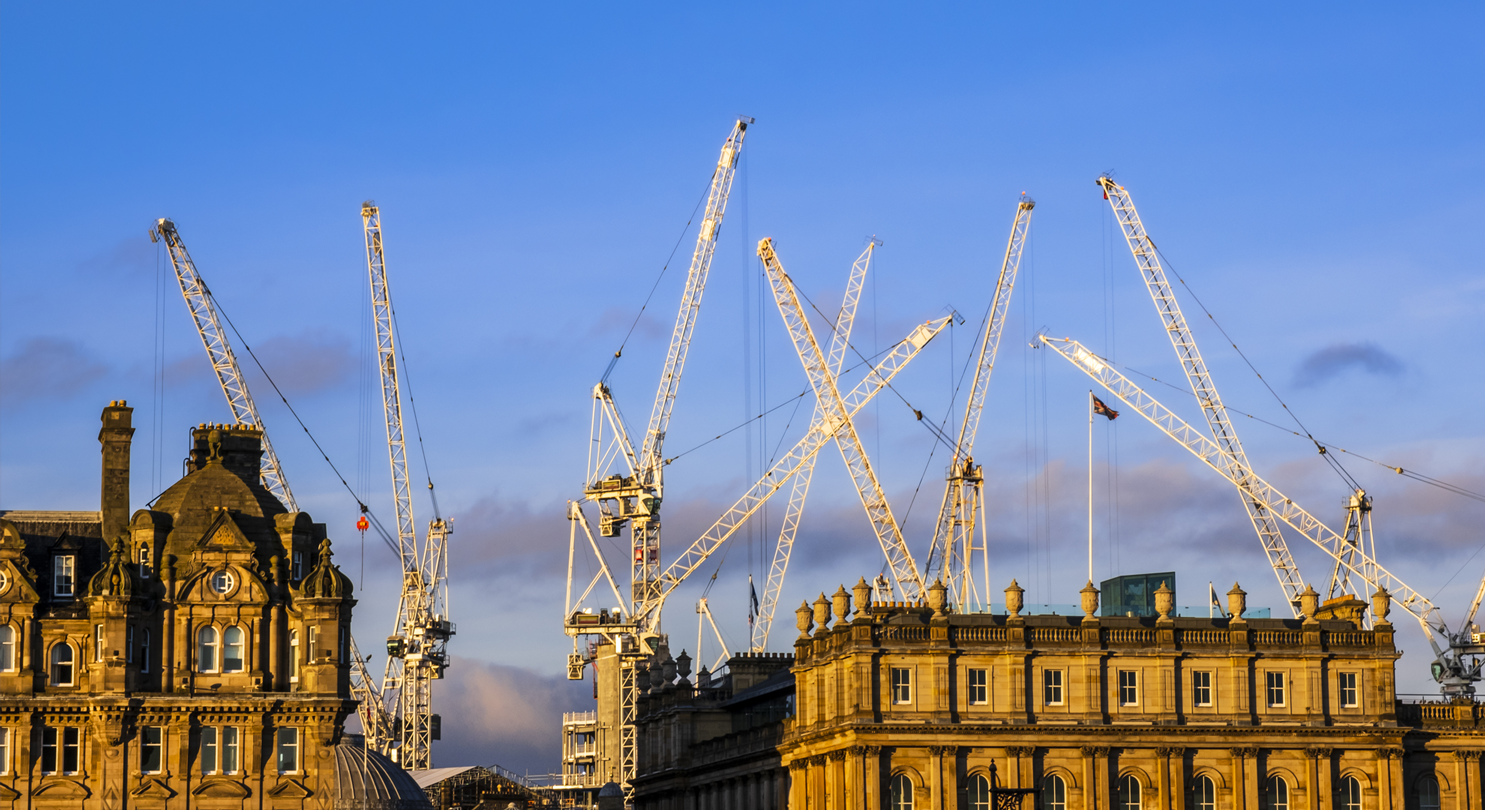 Scottish city skyline with construction cranes working on projects
