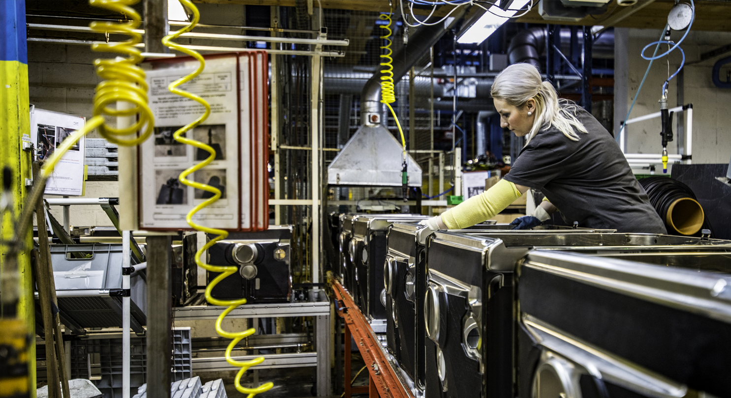 A person working with machinery as part of a manufacturing process