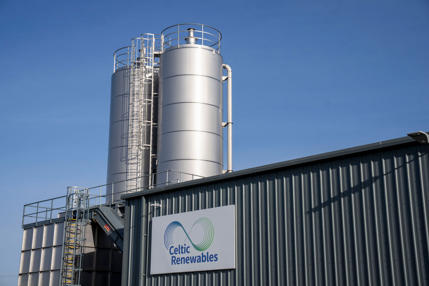 Exterior view of Celtic Renewables facility with large metal tanks and company sign.