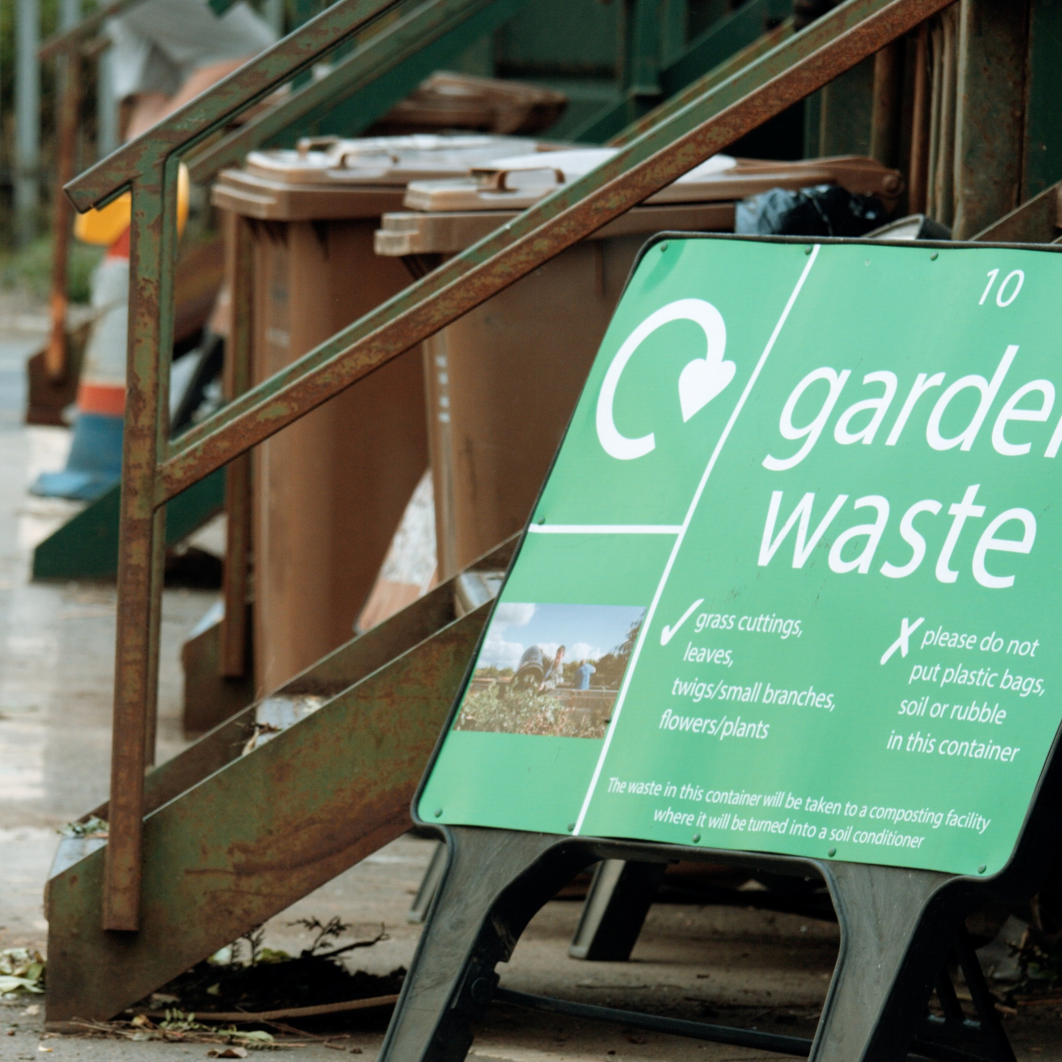 a sign for garden waste sitting in a recycling centre