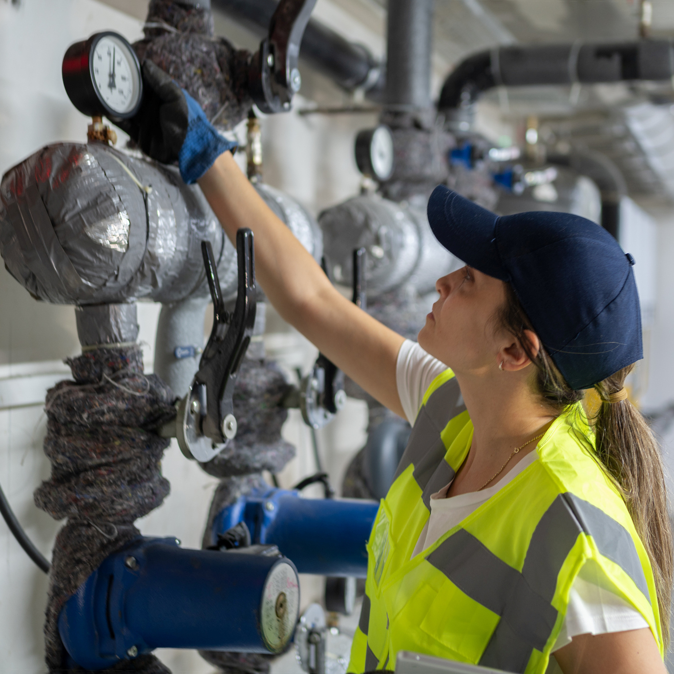A heating technician working on pipes
