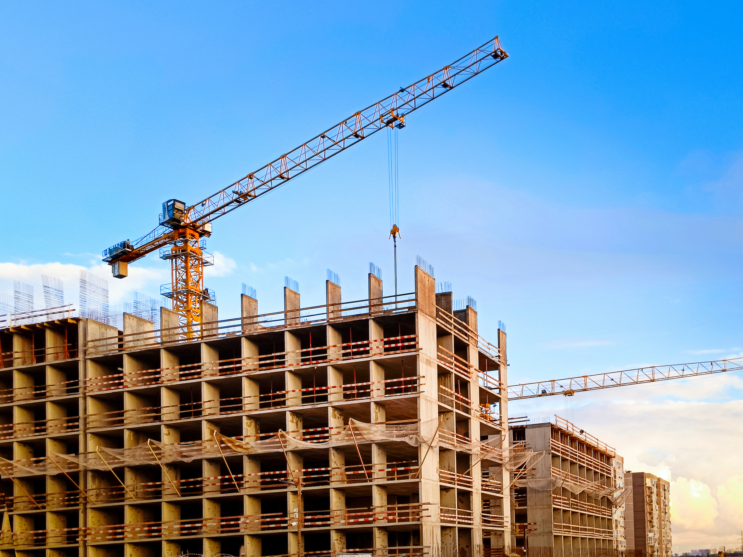 Construction crane above a multistorey building under construction.